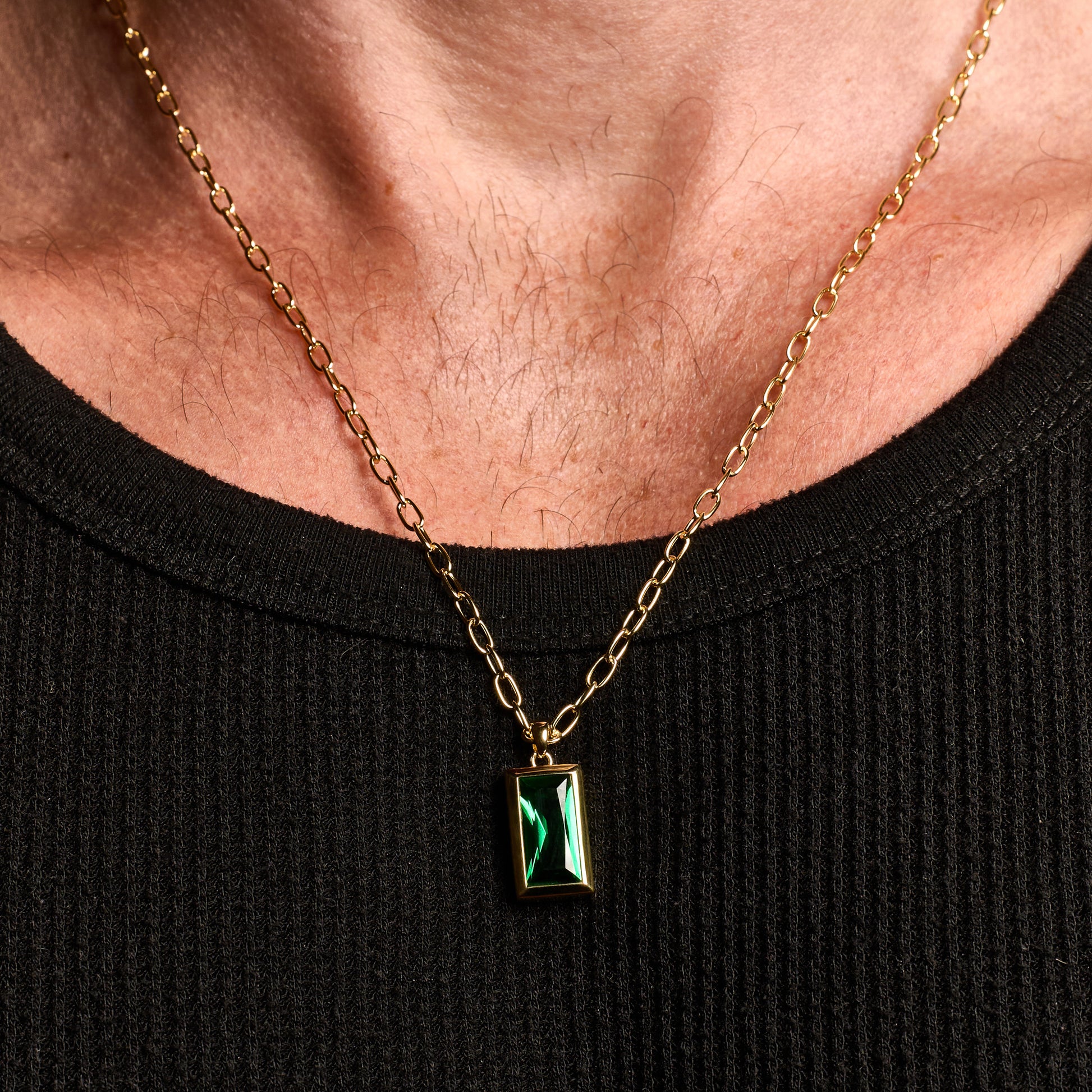 Closeup shot man wearing Emerald Gold Sona Pendant