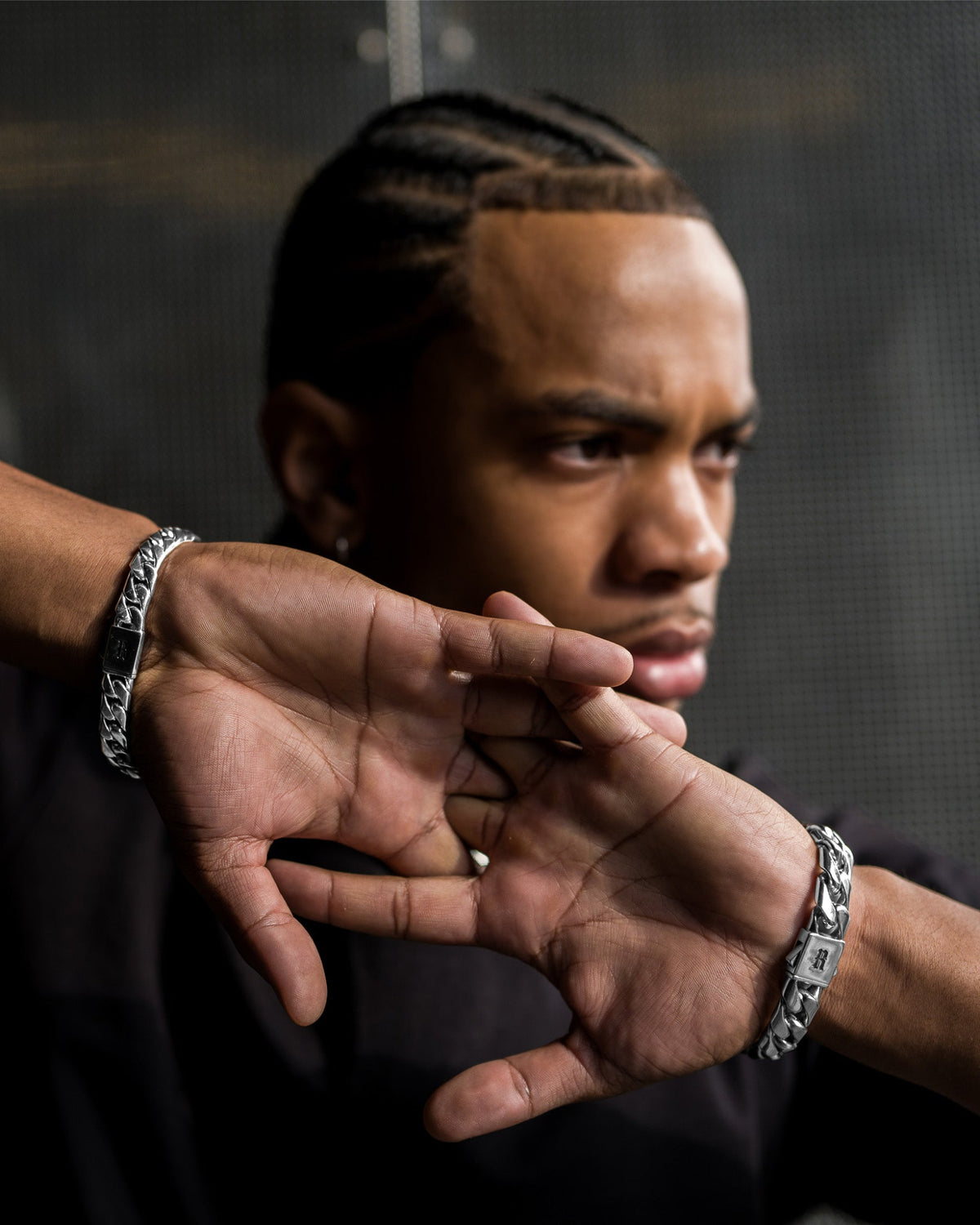 Model wearing the Medium Cuban Bracelet handcrafted from solid 925 sterling silver with polished Cuban links.