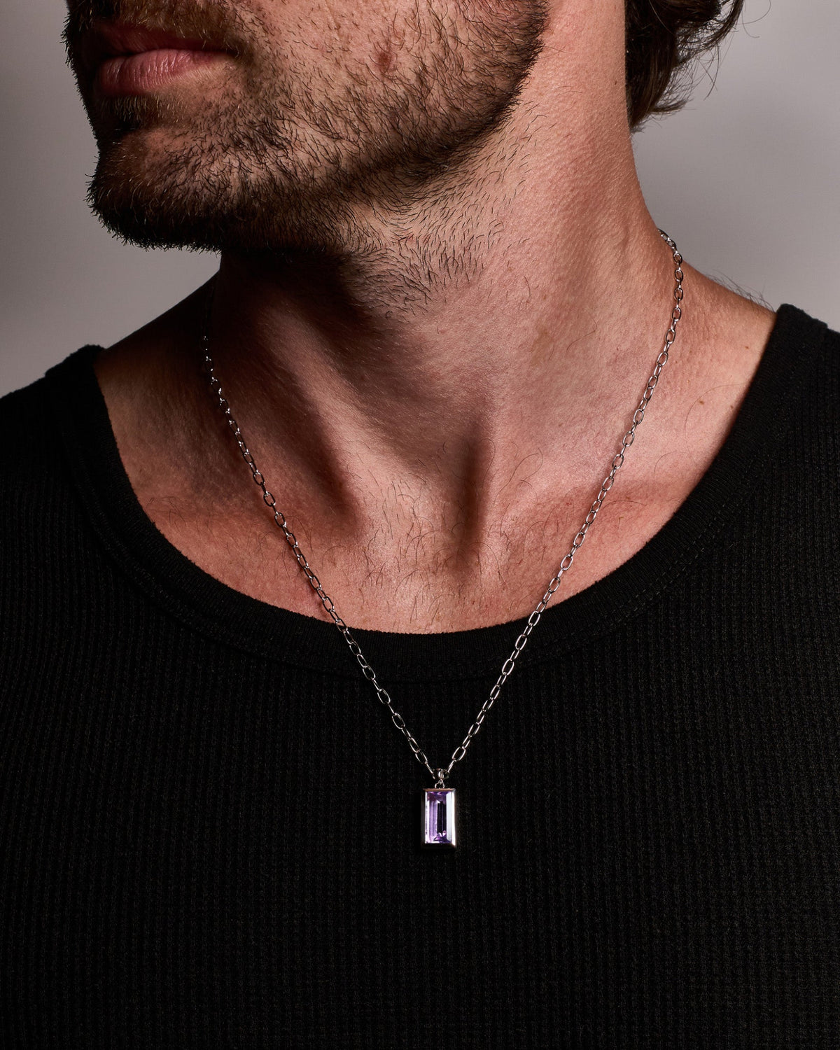 Model wearing the Sona Amethyst Pendant handcrafted from solid 925 sterling silver on a sterling silver necklace.