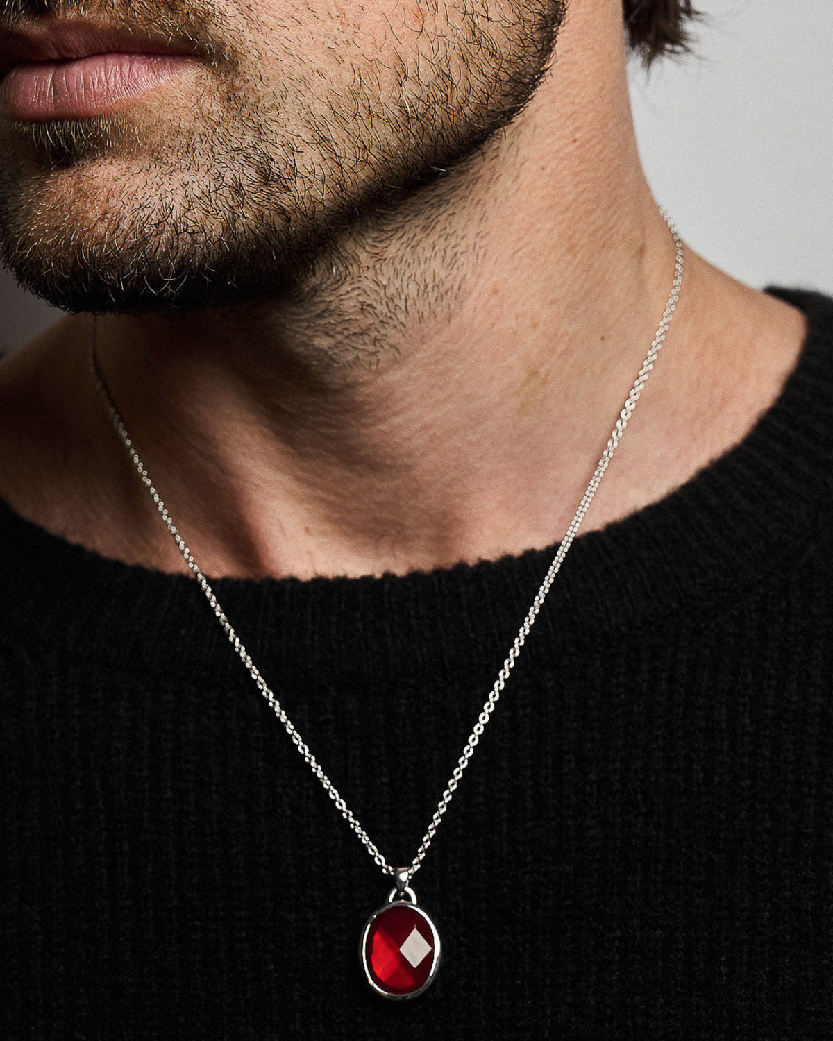 Model wearing the Suki Red Garnet Pendant handcrafted from solid 925 sterling silver on a sterling silver necklace one.