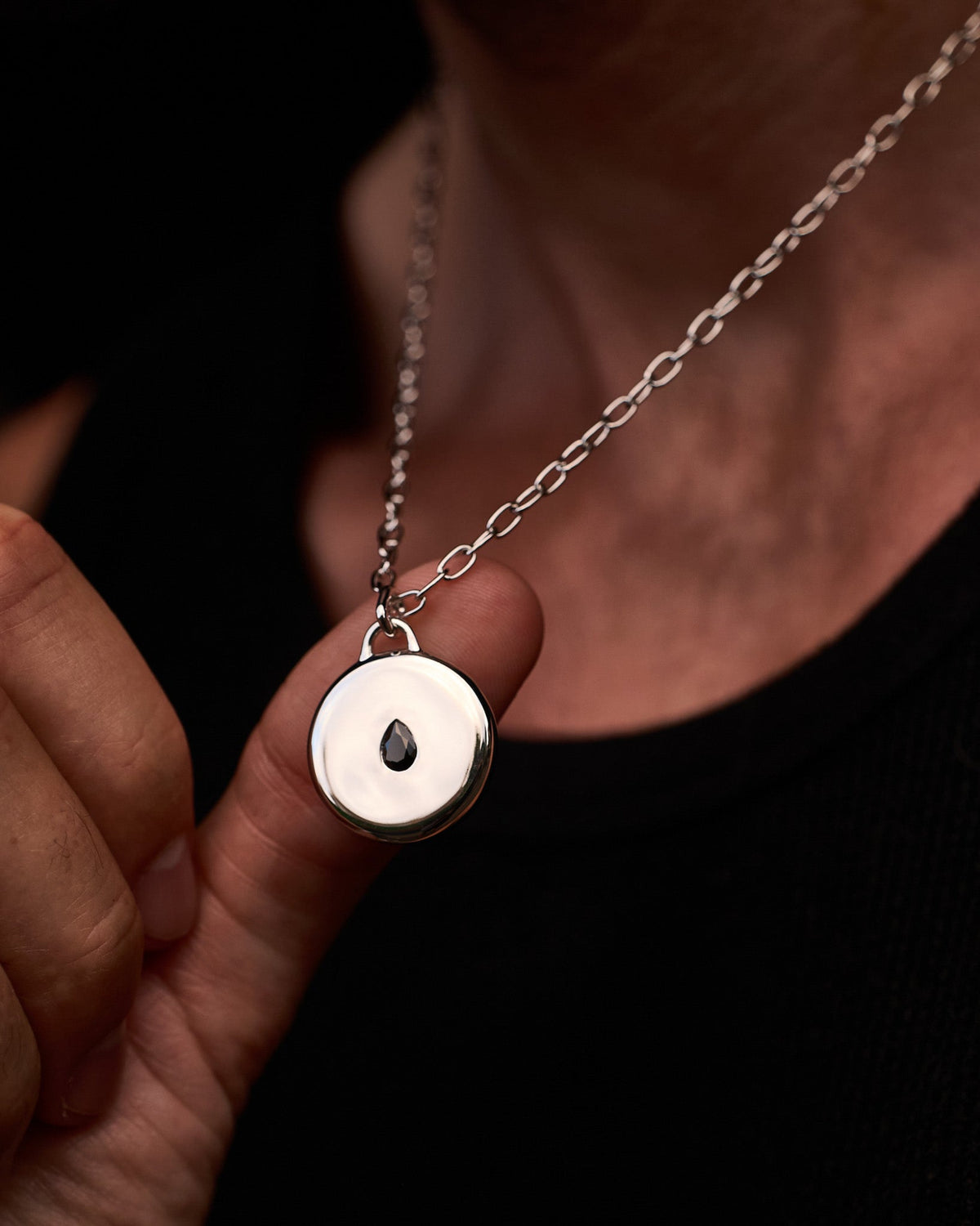 Close-up of the Teardrop Pendant featuring a black teardrop stone set in solid 925 sterling silver.