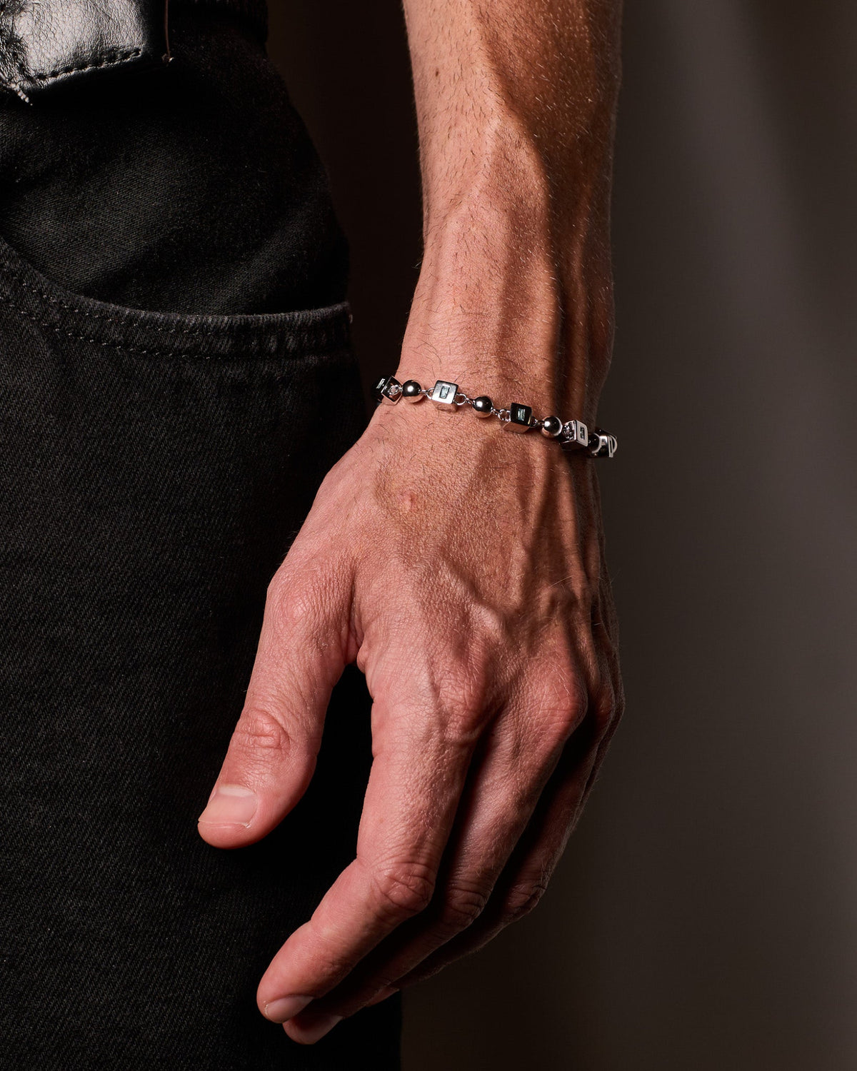 The Topaz Bracelet features handcrafted sterling silver links accented with natural blue topaz stones for a refined statement
