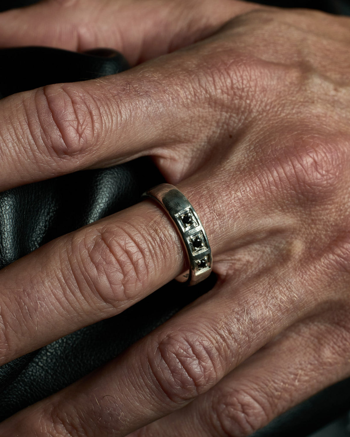 Model wearing the Trilogy Ring handcrafted from solid 925 sterling silver featuring genuine black onyx.