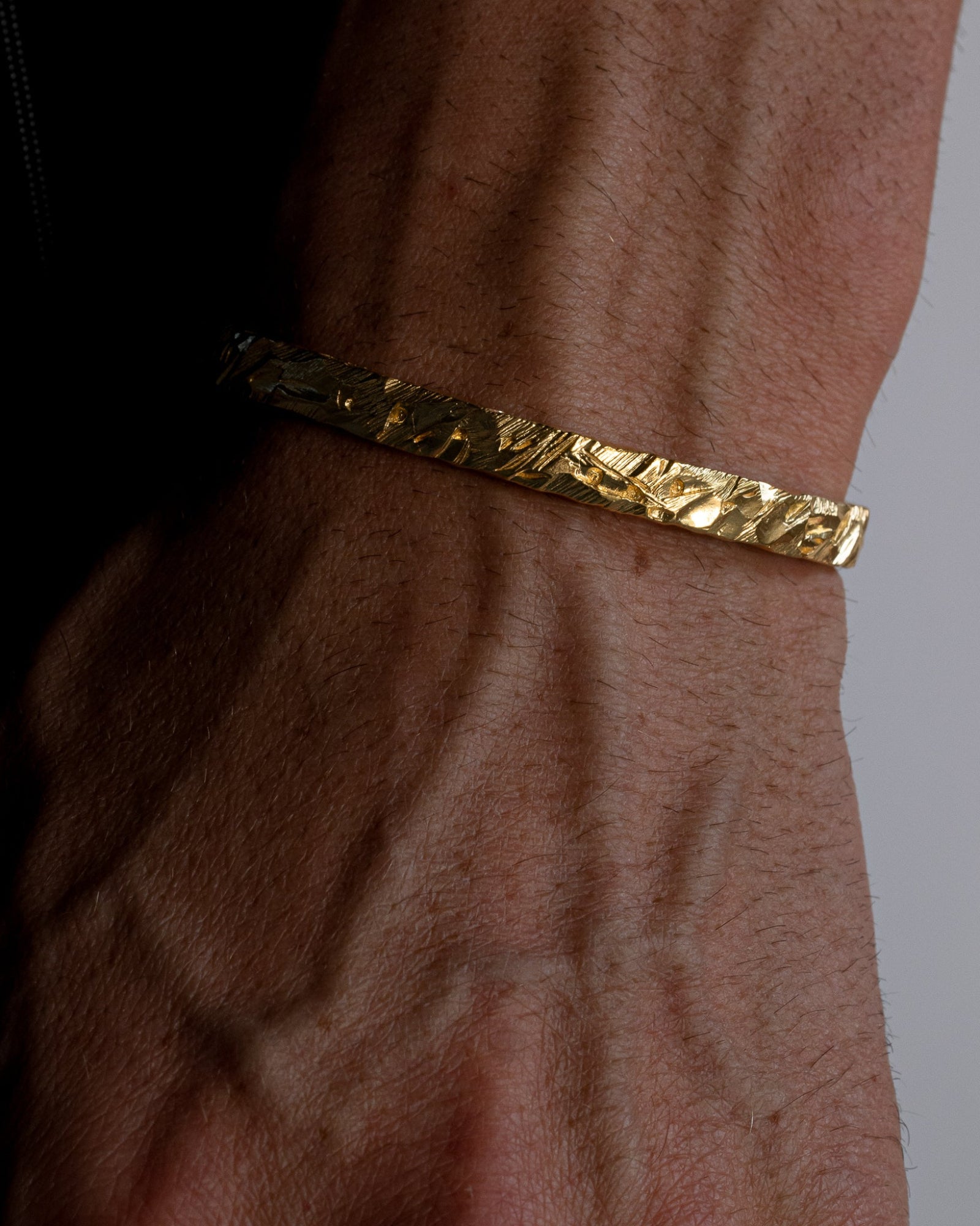 asper cuff bracelet worn on a model's wrist 1